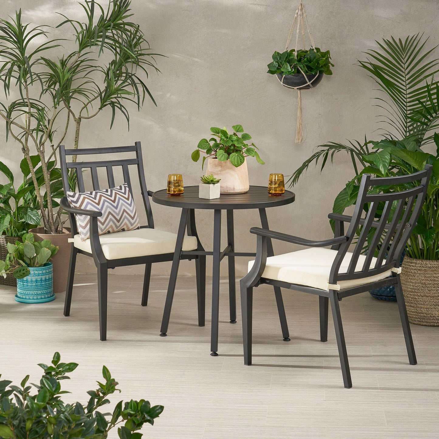 Elegant metal bistro table and chairs set, perfect for stylish outdoor dining spaces