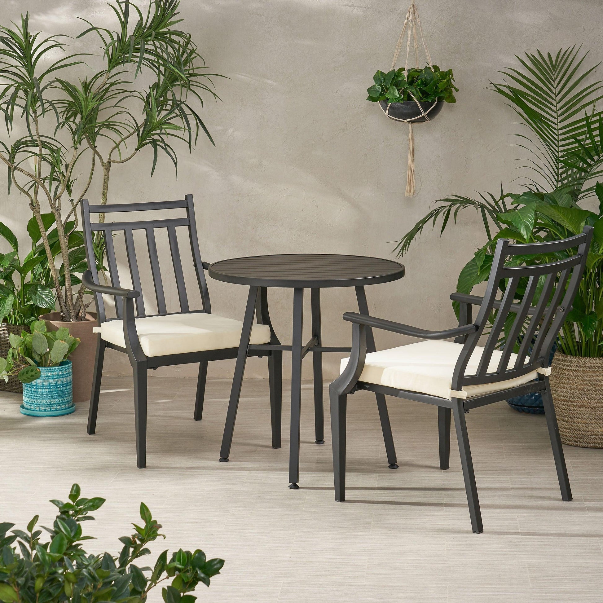 Elegant metal bistro table and chairs set, perfect for stylish outdoor dining spaces