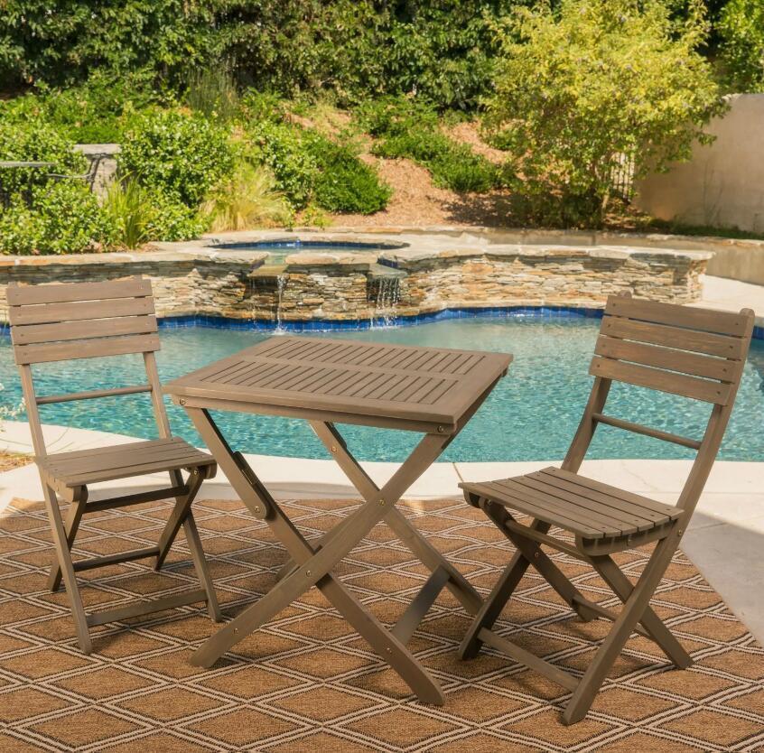 Foldable bistro table and chairs set ideal for compact dining spaces, combining functionality and elegance in design.