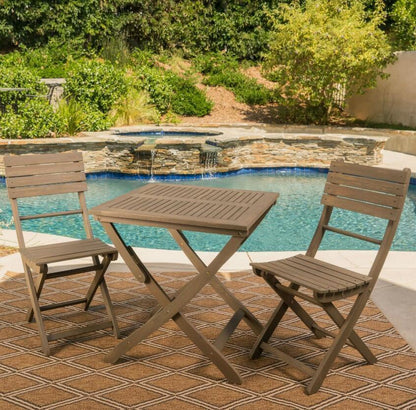Foldable bistro table and chairs set ideal for compact dining spaces, combining functionality and elegance in design.