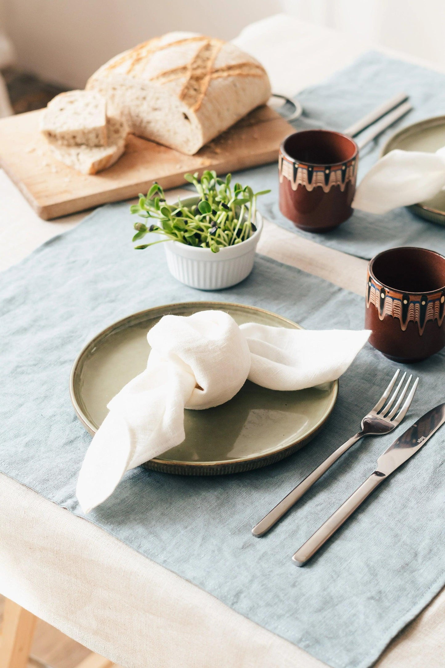 Elegant natural linen napkins arranged neatly on a dining table enhancing eco-friendly decor