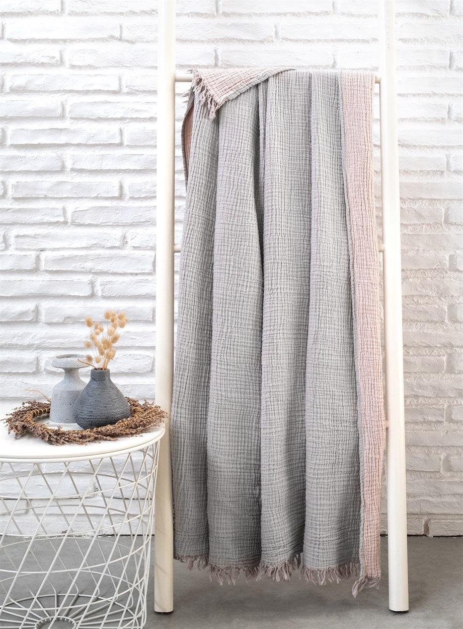 Cozy cotton throw blanket providing warmth and comfort for home and living spaces