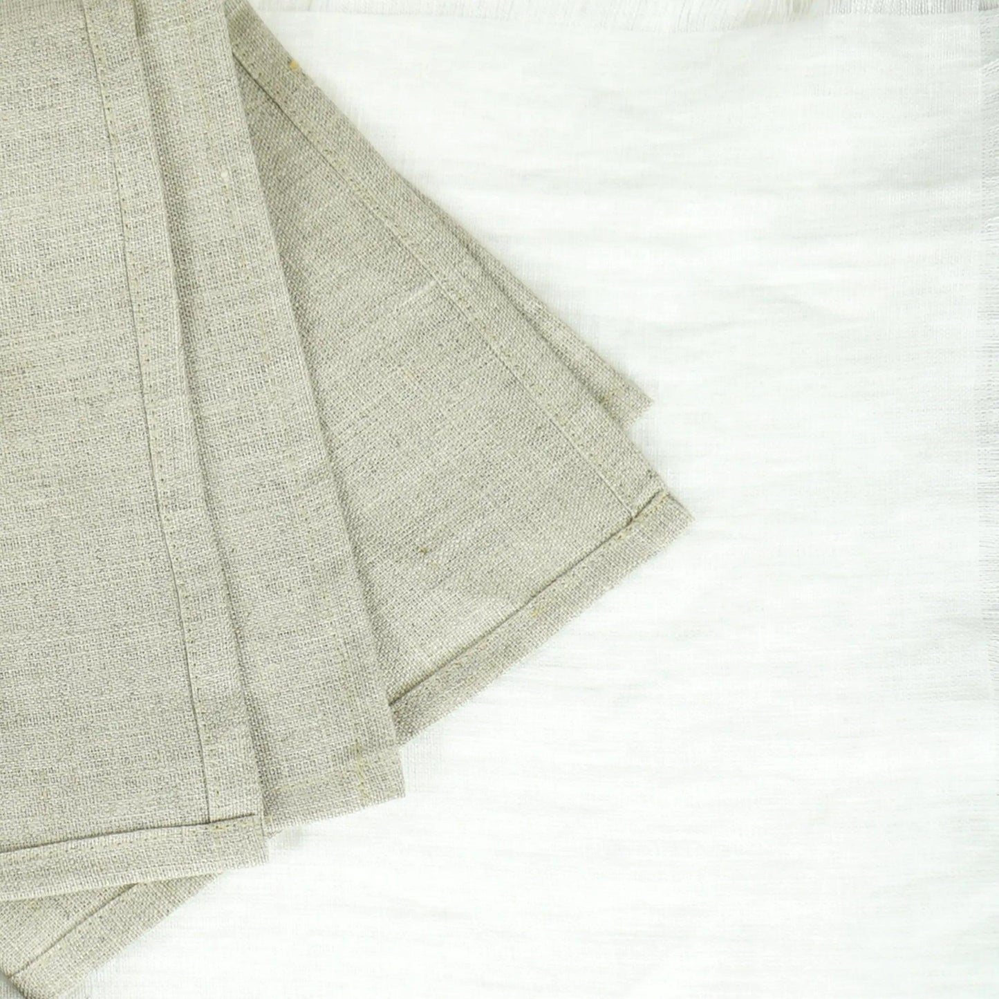 Elegant natural linen napkins arranged neatly on a dining table enhancing eco-friendly decor