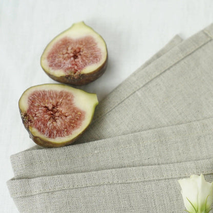 Elegant natural linen napkins arranged neatly on a dining table enhancing eco-friendly decor